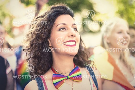 Happy brownhaired woman during the pride parade in...