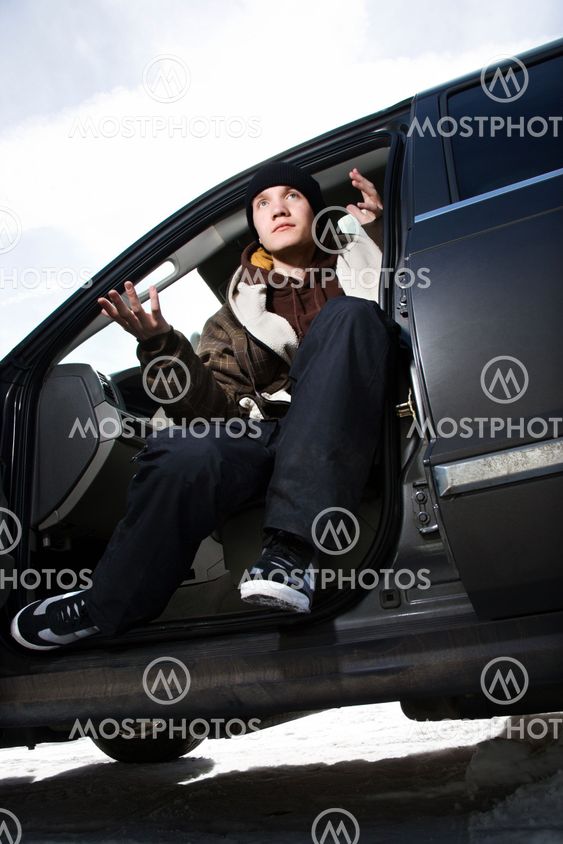 Teen making hand gesture.