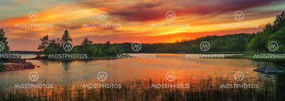 Vivid golden sunset in the archipelago of Scandinavia....