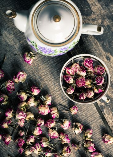 Vintage teapot and cup with blooming tea flowers on...
