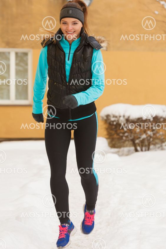 Fit woman running through park.