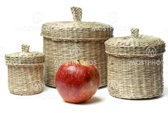 Three wattled baskets and apple isolated