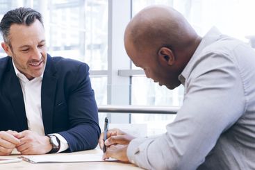 Businessmen, writing or negotiation with signature for...