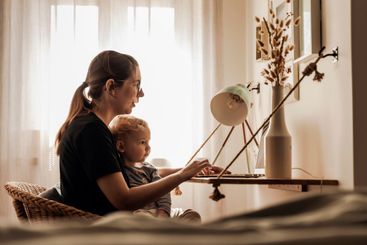 Woman working at home with her baby