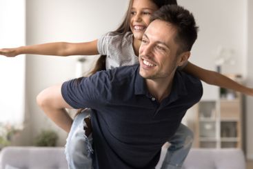 Joyful dad single parent play piggybacking daughter...