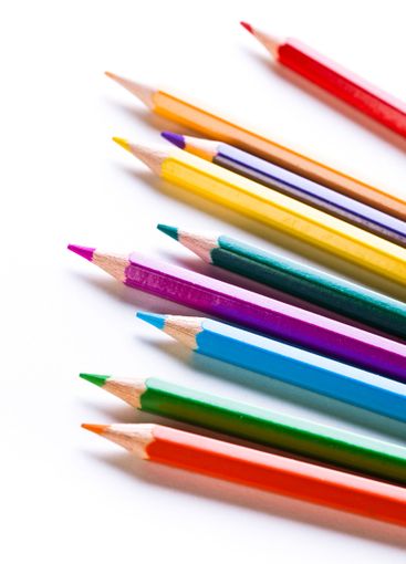 Colorful assortment of sharpened pencils arranged in a...