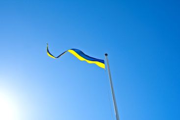 Swedish pennant moving in the wind against blue clear sky