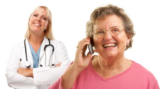 Happy Senior Woman Using Cell Phone with Female Doctor Behind