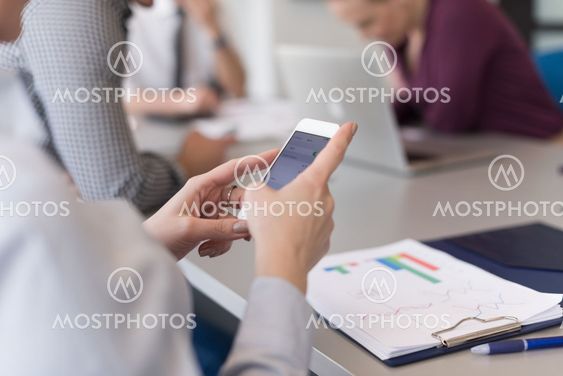 close up of busineswoman hands using smart phone on...