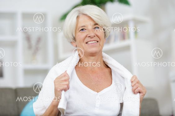 senior woman with a towel around her neck smiling