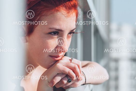 Young girl looking from the balcony