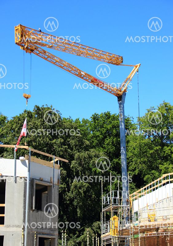 Crane at construction site with blue sky