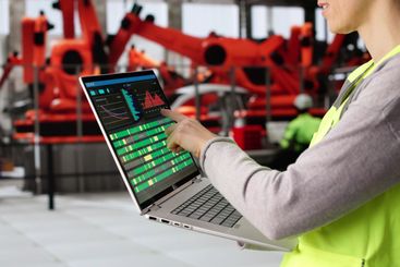 Female Engineer Inspecting Automotive Production Line