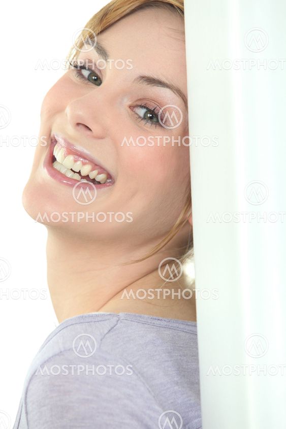 Pretty woman leaning against wall