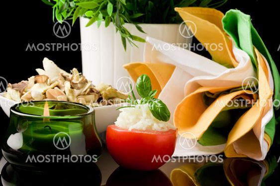 Stuffed Tomatoes with rice on black glass table