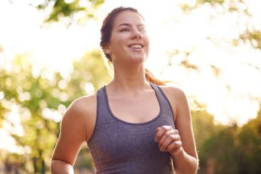 Running, fitness and woman with smile, energy and nature...
