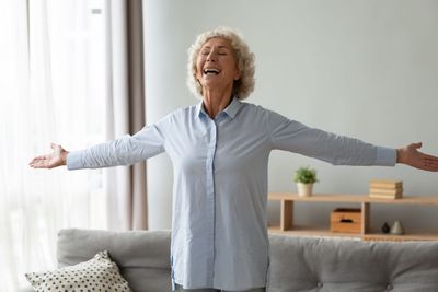 Happy senior woman stretching hands smiling enjoy life...