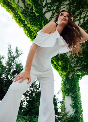 Beautiful fashionable brunette woman in white suit...
