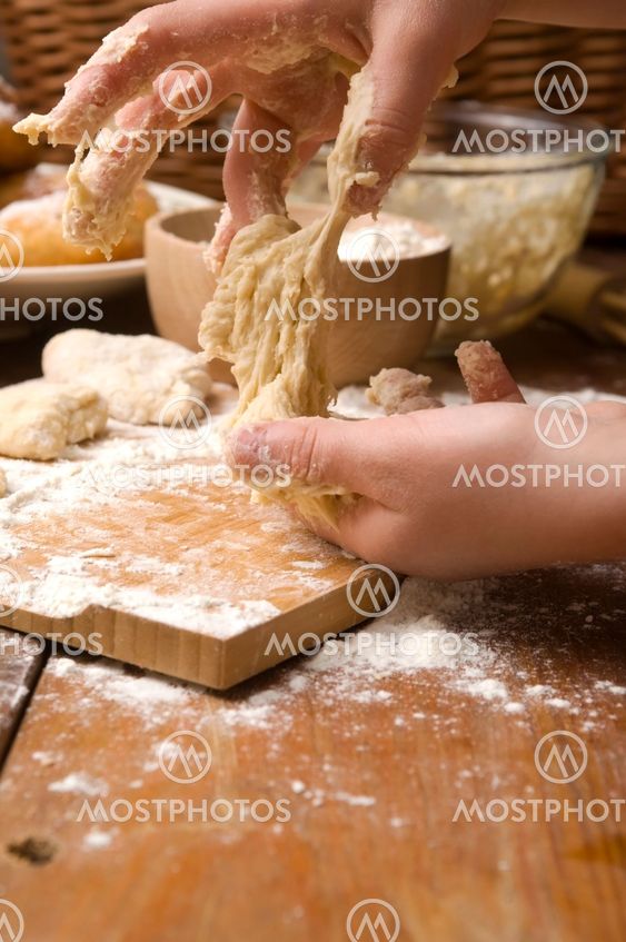 Detail of hands kneading dough