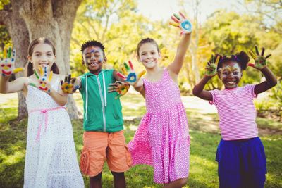 Portrait of cute children with make up having coloured...