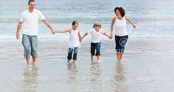 Cute Family on the beach having fun