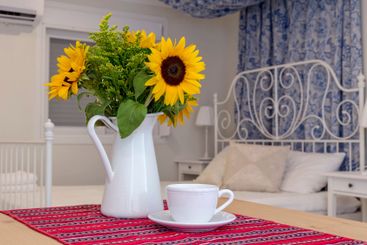 Still life with sunflowers in a vase and a cup of coffee...