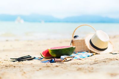 Summer picnic time on a beach. Fresh water melon