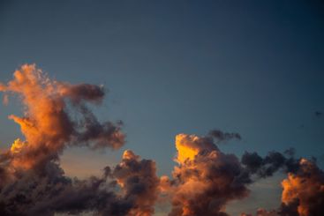 Beautiful orange and yellow clouds create a stunning...
