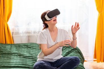 Portrait of woman in home interior interacting with...