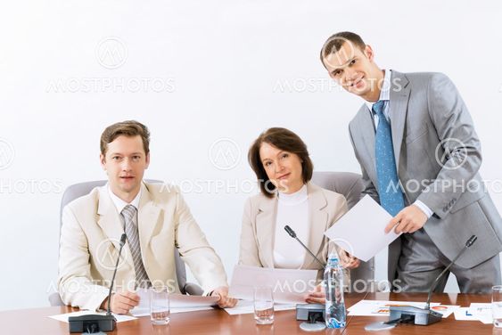 group of business people discussing documents