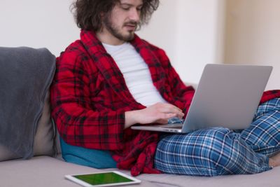 man freelancer in bathrobe working from home