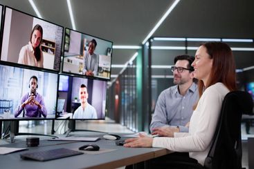 Professional Woman and Mature Executive Hold Online...