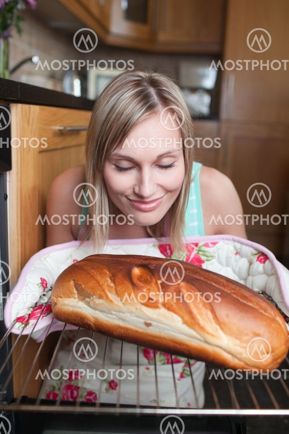Delighted blond woman baking bread