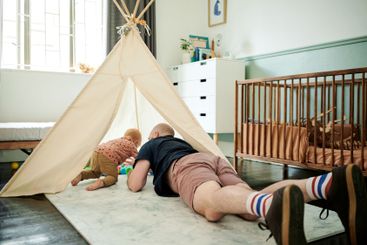 Baby, father and playing with balls in tent at home,...