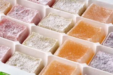 Colorful array of traditional sweets displayed in a...