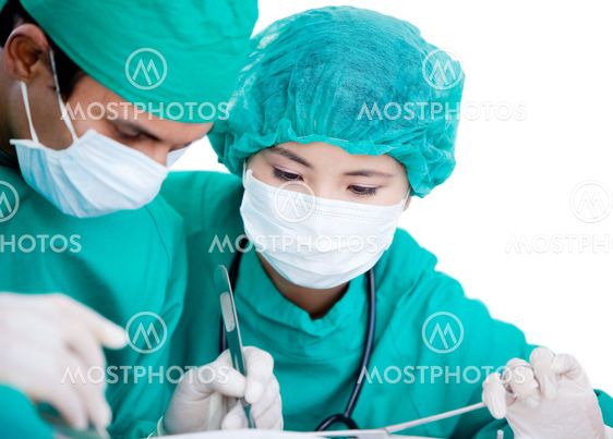 Medical partners making an operation using surgery equipment on