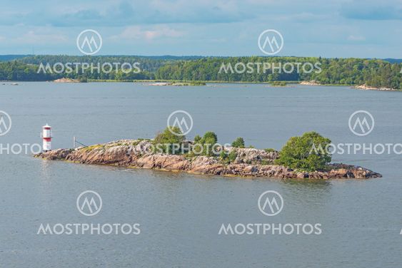View of a small island with a white beacon in the swedish...