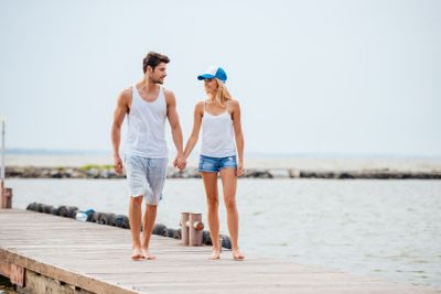 Romantic young beautiful couple walking on the beach...
