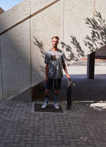 Skateboard, portrait and fitness with man in city for...