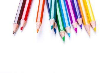 Colorful assortment of sharpened pencils arranged on a...