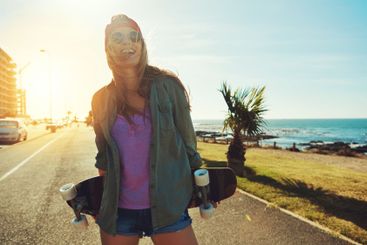 Holiday, road and woman with skateboard, adventure and...
