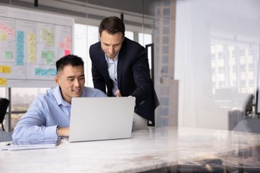 Male Caucasian project leader giving advice, help to...