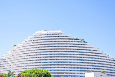 Daylight sunny view to hotel building in trapeze shape...