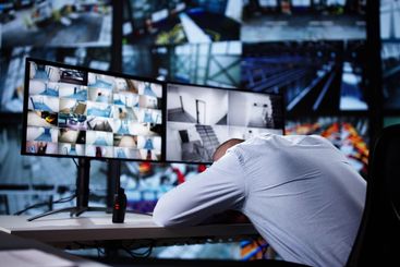 Young Male Operator Sleeping On Desk