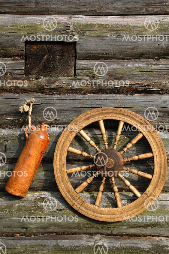 Ceramic Bottle And Spinning Wheel On The Wall