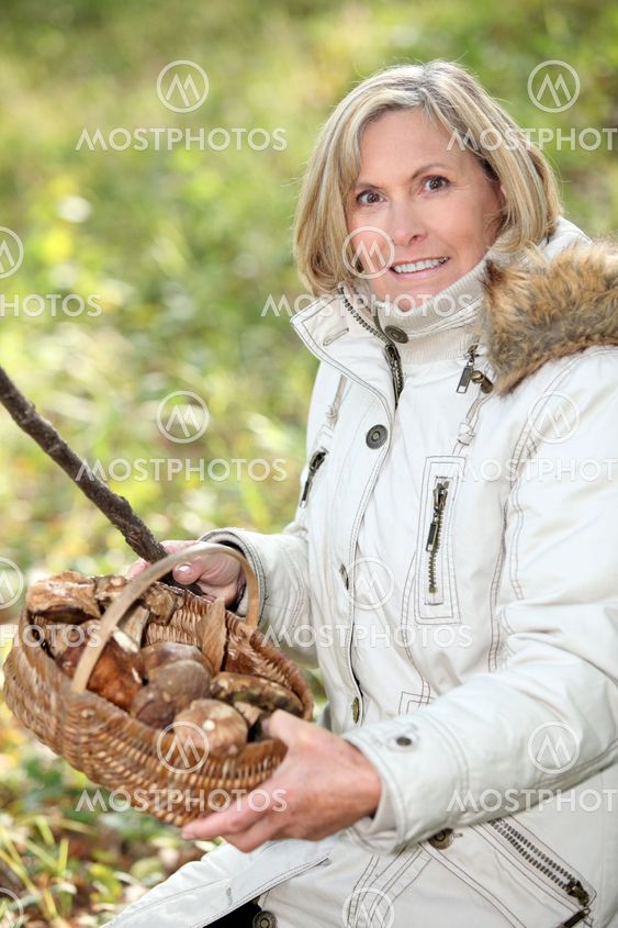 senior woman gathering mushrooms