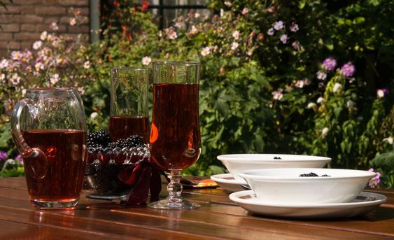 Table with fresh picked blackberries, drinks and yogurt