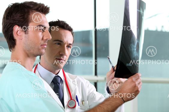 Two medical colleagues looking at x-ray image