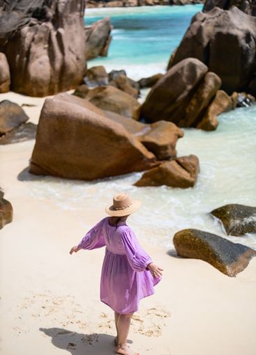 Woman on a beach near rocks