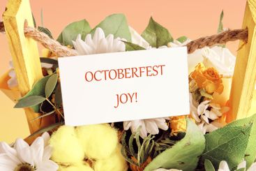 OCTOBERFEST JOY concept words on a white business card...